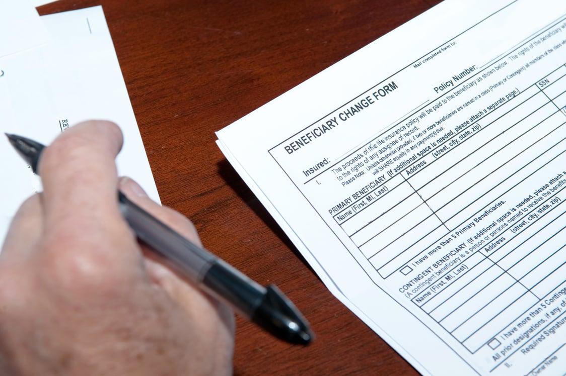 Blank copy of Beneficiary Change Form being read